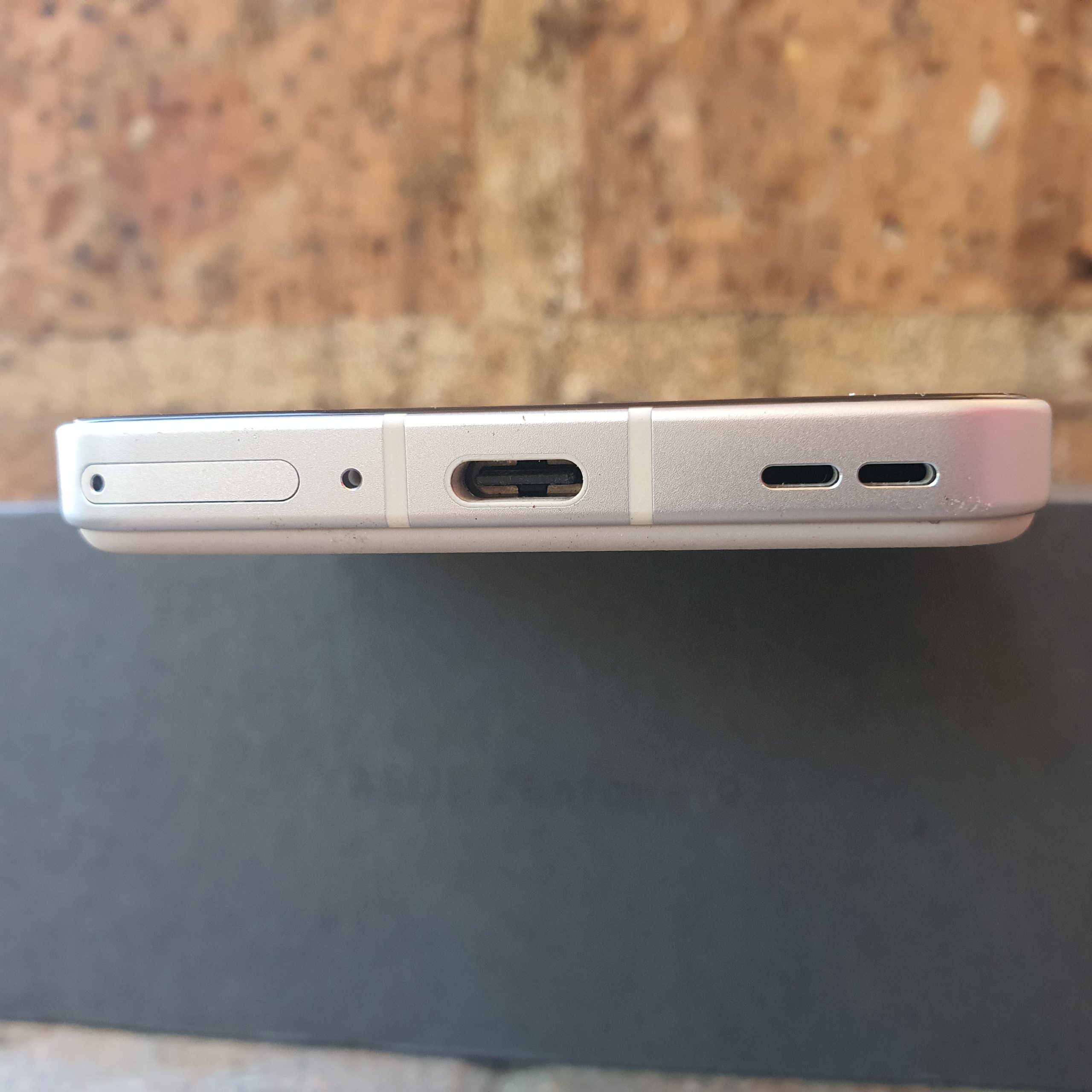Dual SIM card port (left hand side), USB-C port (centre) and speaker grill (right hand side) - bottom