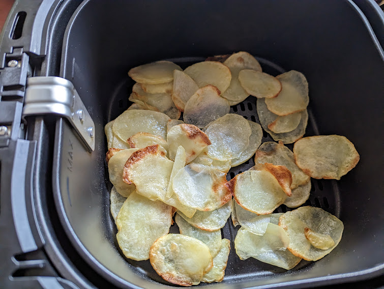 partly cooked potato slices in an airfryer basket