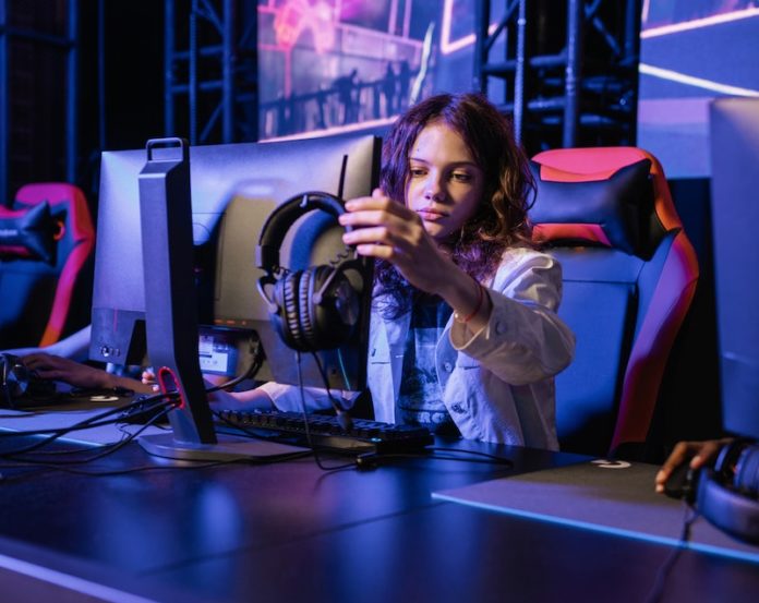 Photo of a Girl Touching a Monitor