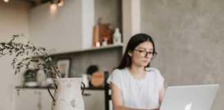 Focused young businesswoman working remotely at home