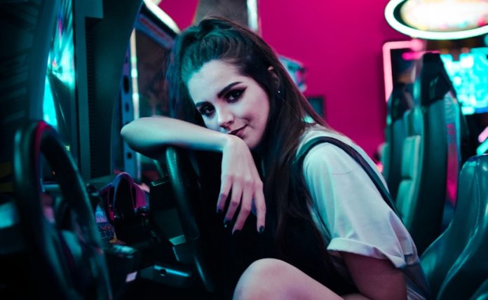 woman sitting on car arcade machine