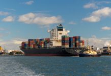 cargo ship on sea under blue sky during daytime