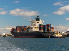 cargo ship on sea under blue sky during daytime