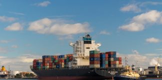 cargo ship on sea under blue sky during daytime