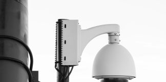white security camera on post