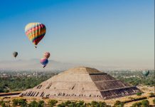 Best apps for travelers a group of hot air balloons flying over a pyramid