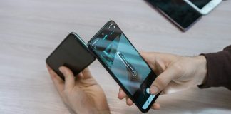 a person holding a smart phone in their hand