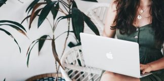 woman sitting and using MacBook