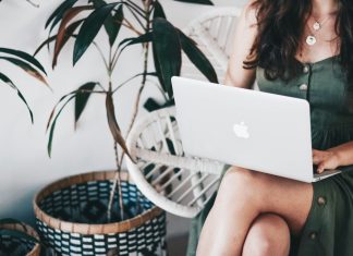 woman sitting and using MacBook