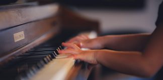 person playing upright piano
